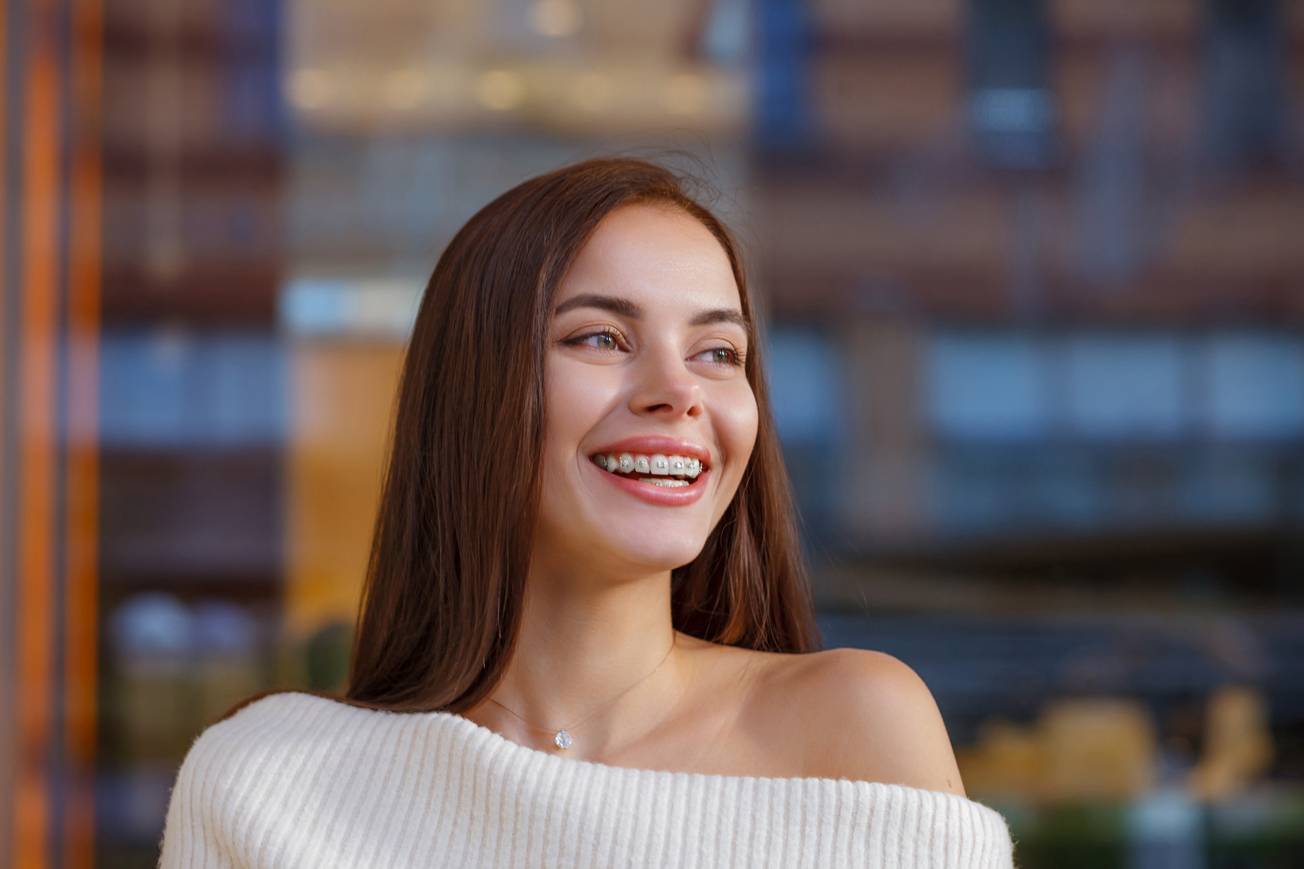 AdobeStock_464268644 v2 Woman smiling with her beautiful braces from Modern Orthodontics in New York