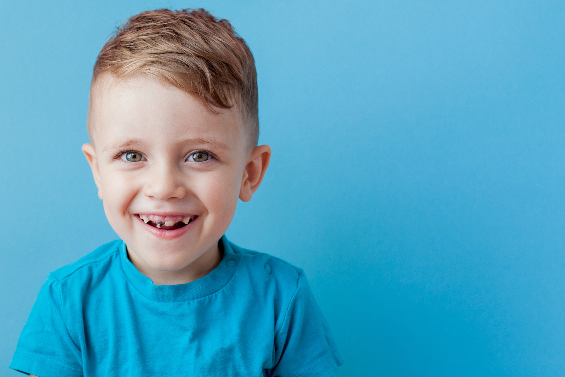 Little boy smiling with crooked teeth in need of early orthodontic care in New York NY